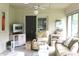 Comfortable sun room with cozy seating arrangements, a TV, and a ceiling fan at 215 Fairway Ct, Franklin, IN 46131