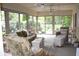 Bright and airy sun room with comfortable wicker furniture and large windows at 215 Fairway Ct, Franklin, IN 46131