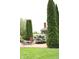 Lawn featuring a stone patio, outdoor furniture, tall columnar trees, and a large blooming bush at 215 Fairway Ct, Franklin, IN 46131