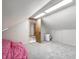 An attic room offers carpet, access to storage, and potential for a unique space at 225 Yorkshire E Blvd, Indianapolis, IN 46229