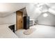 An attic with carpet, desk, and storage shelves provides flexible space for storage or activities at 225 Yorkshire E Blvd, Indianapolis, IN 46229