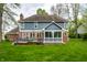 A full back exterior shot highlights the deck, screened-in porch, and well-maintained backyard at 225 Yorkshire E Blvd, Indianapolis, IN 46229