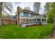 A wide shot of the rear exterior shows a deck, sunroom, and yard ready for outdoor living at 225 Yorkshire E Blvd, Indianapolis, IN 46229