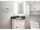 Stylish bathroom with granite countertop, white cabinetry, and modern lighting at 225 Yorkshire E Blvd, Indianapolis, IN 46229