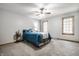 Carpeted bedroom with a ceiling fan, neutral walls, and natural light from the window at 225 Yorkshire E Blvd, Indianapolis, IN 46229