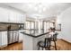 Open concept kitchen with granite island, stainless steel appliances, and hardwood floors at 225 Yorkshire E Blvd, Indianapolis, IN 46229