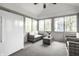 Bright sunroom with wicker seating, a ceiling fan and a view of the yard at 225 Yorkshire E Blvd, Indianapolis, IN 46229