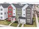 Aerial view of townhomes featuring a black roof, colorful facades, and well-manicured front yards at 2418 Winthrop Ave, Indianapolis, IN 46205