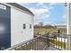 Balcony view overlooking the community with black metal railing and blue and white siding at 2418 Winthrop Ave, Indianapolis, IN 46205