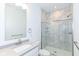 Modern bathroom with marble-look shower, glass door, a floating vanity and chrome fixtures at 2418 Winthrop Ave, Indianapolis, IN 46205