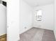Cozy, carpeted bedroom with a window and minimal furnishings at 2418 Winthrop Ave, Indianapolis, IN 46205
