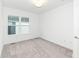 Neutral bedroom with large window featuring plush carpet and white walls for personalization at 2418 Winthrop Ave, Indianapolis, IN 46205