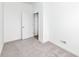 Bright, carpeted bedroom featuring a doorway and white walls at 2418 Winthrop Ave, Indianapolis, IN 46205