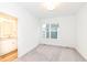 Bright bedroom featuring a large window, neutral carpet and an ensuite bathroom at 2418 Winthrop Ave, Indianapolis, IN 46205