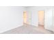 Bright bedroom featuring neutral carpeting and trim, complemented by two white doors at 2418 Winthrop Ave, Indianapolis, IN 46205