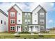 Charming townhomes featuring colorful facades, white trim, and well-manicured front yards at 2418 Winthrop Ave, Indianapolis, IN 46205