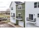 View of new townhomes with individual garage doors and black metal balcony railings at 2418 Winthrop Ave, Indianapolis, IN 46205