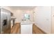 Bright kitchen featuring stainless steel appliances, a central island and access to the outdoor balcony at 2418 Winthrop Ave, Indianapolis, IN 46205