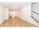 Open-concept floor plan with staircase and kitchen including light wood flooring and recessed lighting at 2418 Winthrop Ave, Indianapolis, IN 46205