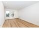 Bright living room featuring hardwood floors and ample natural light from two windows at 2418 Winthrop Ave, Indianapolis, IN 46205