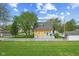 Expansive backyard featuring a well-maintained lawn, a white picket fence, and a deck, perfect for outdoor enjoyment at 25 N Wayburn St, Indianapolis, IN 46229