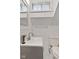 Cozy bathroom featuring white subway tile, modern fixtures, and natural light from the window at 25 N Wayburn St, Indianapolis, IN 46229