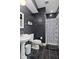Modern bathroom featuring a pedestal sink, toilet, stylish fixtures, and a shower with a patterned curtain at 25 N Wayburn St, Indianapolis, IN 46229