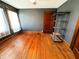 Bedroom featuring hardwood floors and dark walls at 25 N Wayburn St, Indianapolis, IN 46229