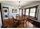 Charming dining area with a round table, wooden chairs, and a laundry area at 25 N Wayburn St, Indianapolis, IN 46229
