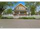 Charming two-story home with a classic white picket fence and lush greenery, perfect for enjoying the outdoors at 25 N Wayburn St, Indianapolis, IN 46229