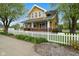 Beautiful two-story home featuring a welcoming porch and a well-manicured yard at 25 N Wayburn St, Indianapolis, IN 46229