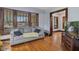 Inviting living room showcasing a comfortable gray sofa, hardwood floors, and classic wood-framed windows at 25 N Wayburn St, Indianapolis, IN 46229