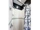 White tiled shower with a contrasting black ceiling and a patterned curtain at 25 N Wayburn St, Indianapolis, IN 46229