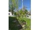 Well-maintained yard featuring a small tree, a stone planter, and a classic white picket fence at 25 N Wayburn St, Indianapolis, IN 46229
