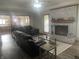 Comfortable living room featuring a brick fireplace, wood floors, and a view into the kitchen at 2550 16Th St, Columbus, IN 47201