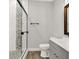 Beautifully remodeled bathroom featuring walk-in shower with pebble accents and modern vanity at 257 N Tacoma Ave, Indianapolis, IN 46201