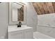 Bright bathroom featuring modern vanity, updated mirror and walk-in shower with decorative tile at 257 N Tacoma Ave, Indianapolis, IN 46201