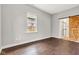 Bright bedroom with wood floors and sliding barn door leading to a remodeled bathroom at 257 N Tacoma Ave, Indianapolis, IN 46201