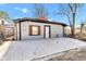 Exterior shot of garage, showing a large concrete driveway, decorative shutters, and modern paint at 257 N Tacoma Ave, Indianapolis, IN 46201