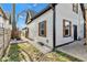 Exterior showcasing fresh siding, black gutters, decorative wood shutters, and landscaping details at 257 N Tacoma Ave, Indianapolis, IN 46201