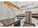 Modern kitchen boasts an island with a black countertop, stainless steel appliances, and white cabinets at 257 N Tacoma Ave, Indianapolis, IN 46201