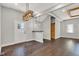 Open floor plan with hardwood floors, modern light fixtures, and white door and sliding wood door at 257 N Tacoma Ave, Indianapolis, IN 46201