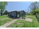 Exterior view of the backyard and home featuring a covered patio and open green space at 2658 S Rybolt Ave, Indianapolis, IN 46241