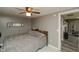 Comfortable bedroom with a ceiling fan, mirror, and cozy gray decor at 2658 S Rybolt Ave, Indianapolis, IN 46241