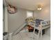 Bedroom featuring a loft bed with a slide, grey walls, geometric carpet, and a ceiling fan at 2658 S Rybolt Ave, Indianapolis, IN 46241