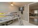 Bedroom featuring a loft bed with a ladder, grey walls, geometric carpet, and a ceiling fan at 2658 S Rybolt Ave, Indianapolis, IN 46241