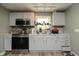 Well lit kitchen featuring stainless steel appliances, light gray cabinets, and a double bowl sink at 2658 S Rybolt Ave, Indianapolis, IN 46241