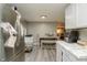 Open concept kitchen with a stainless steel refrigerator leading to a dining area and living space at 2658 S Rybolt Ave, Indianapolis, IN 46241