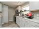 Well lit kitchen featuring stainless steel appliances, light gray cabinets, and light gray flooring at 2658 S Rybolt Ave, Indianapolis, IN 46241