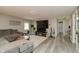 Cozy living room boasts modern gray flooring, an entertainment center, and a comfortable sectional couch at 2658 S Rybolt Ave, Indianapolis, IN 46241